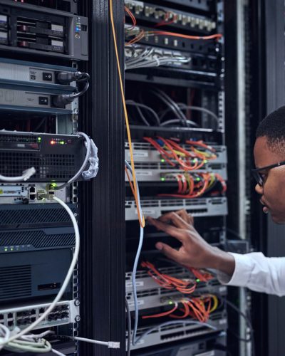 Cropped shot of a IT technician working and checking if all the servers are up and running